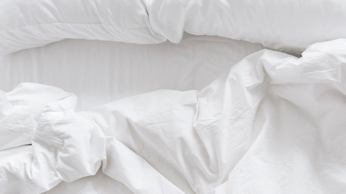 Close-up of a freshly made white duvet with soft, crumpled texture