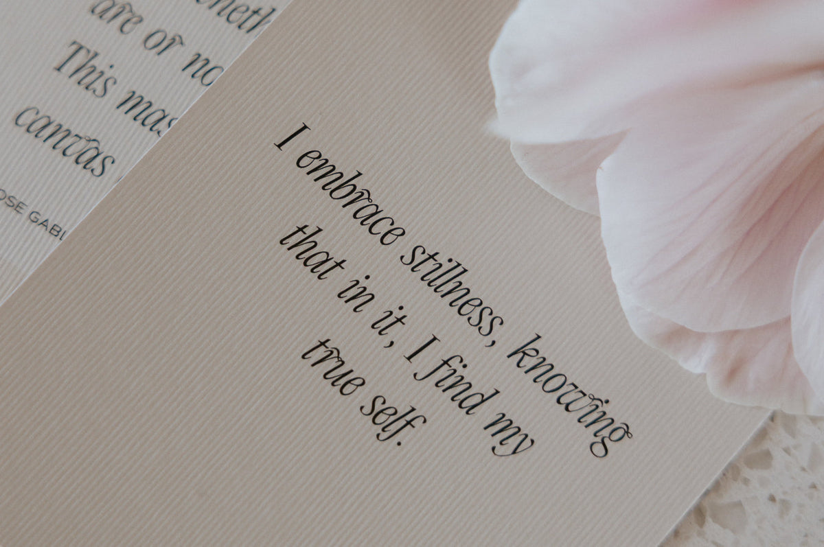 Two affirmation cards resting on soft white fabric