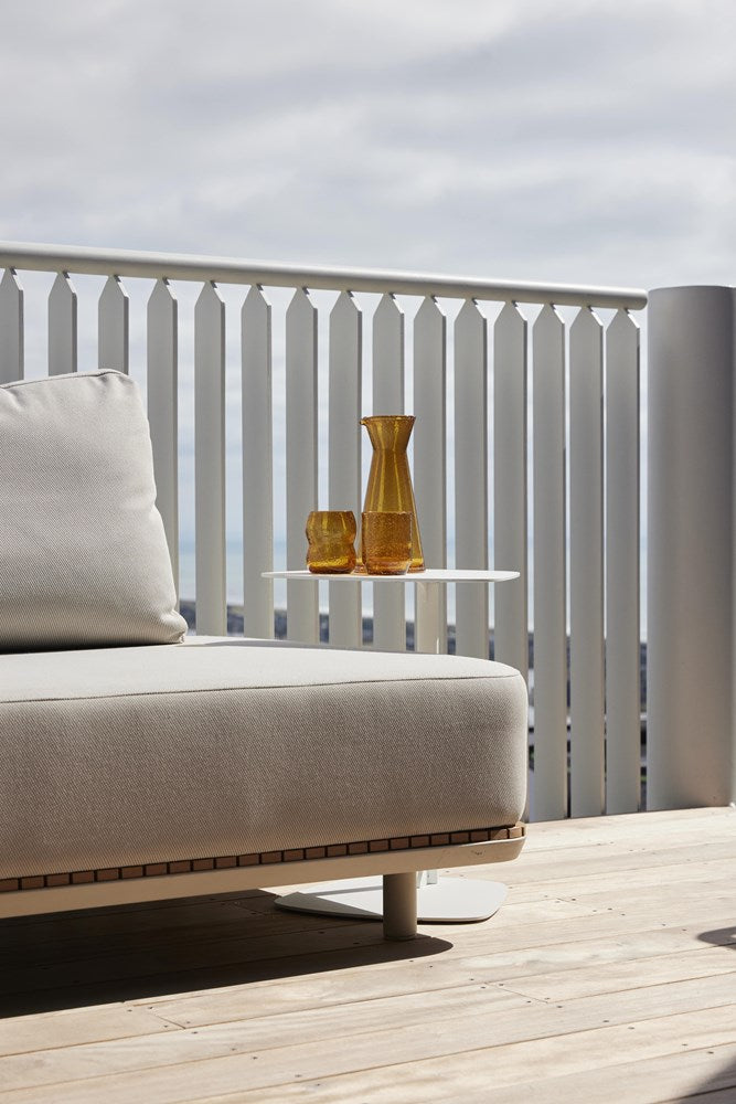 Carafe and tumblers in a deeper amber colour not sold on this listing, on a table by an outdoor sofa