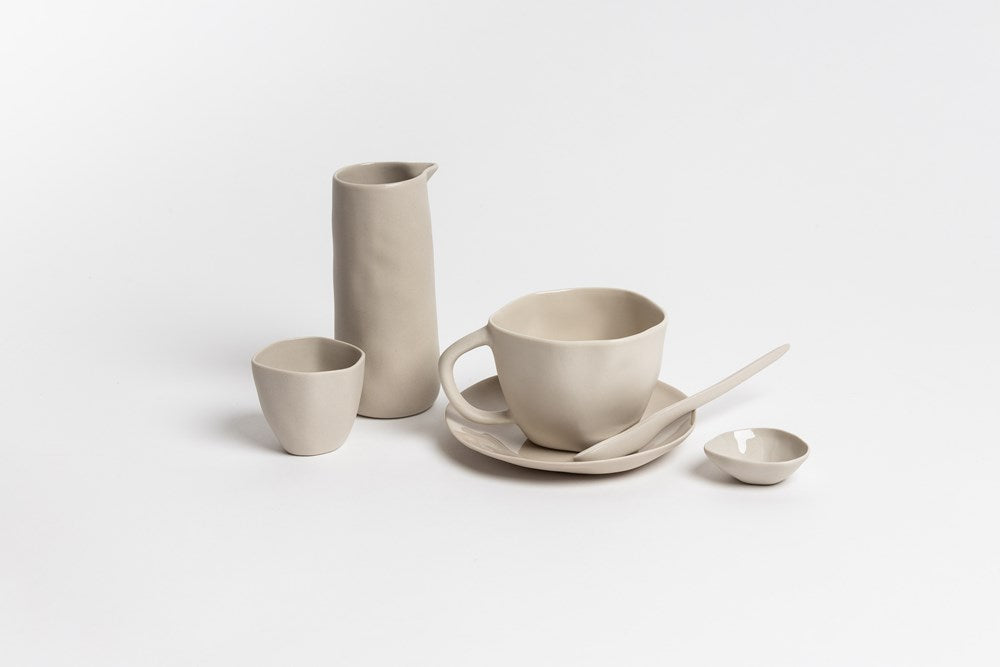 Bone Haan tableware with a cup, saucer, mini dish and vases, on pale grey