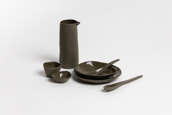 A set of Ned Collections Round Dish plates, bowls and spoons in olive green stoneware.