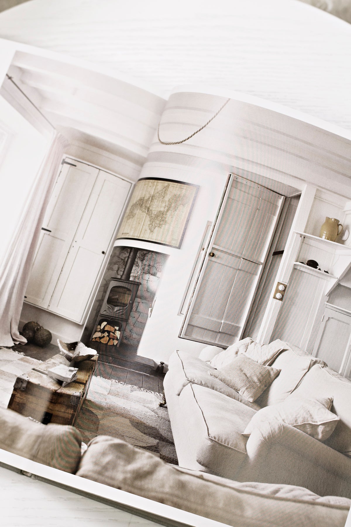 Calm interiors book styled in a living room setting