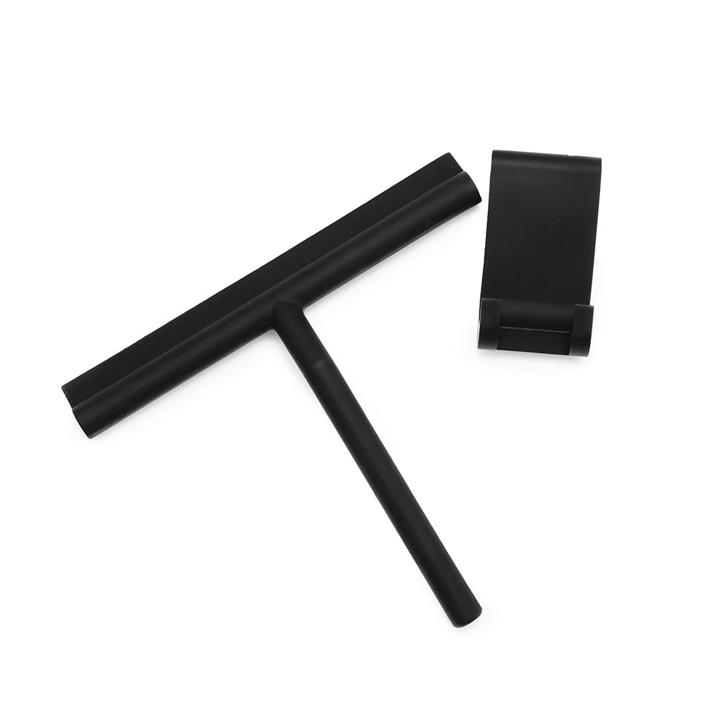 Black silicone squeegee with its separate hook, laid flat on white