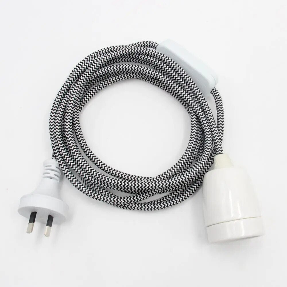 Black and white flex cord set with plug and white E27 lamp holder, coiled on white