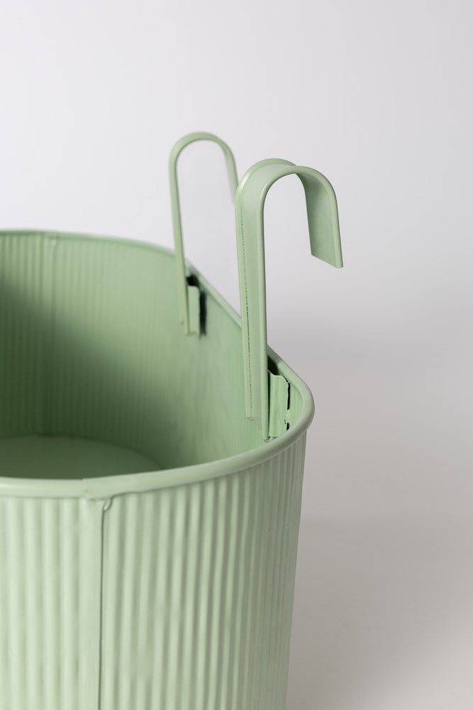 Close view of the sage green Juno planter and its hooks