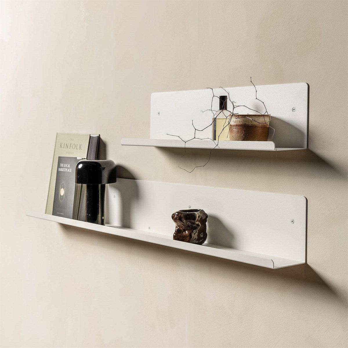 FOLD Display Ledge 600mm White mounted in a kitchen with a small potted plant