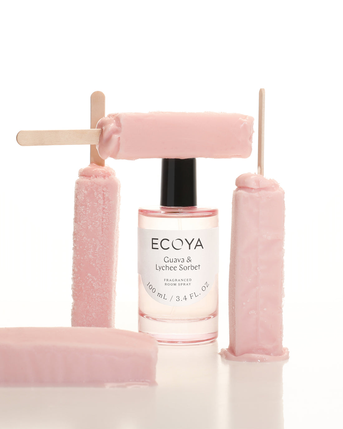 Pink Ecoya room spray among pink sculptural blocks on a white surface