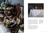 A magazine spread showcasing a beautifully styled table full of delectable food featuring "Natural Tables: Nature-Inspired Tablescapes for Memorable Gatherings" by Books.