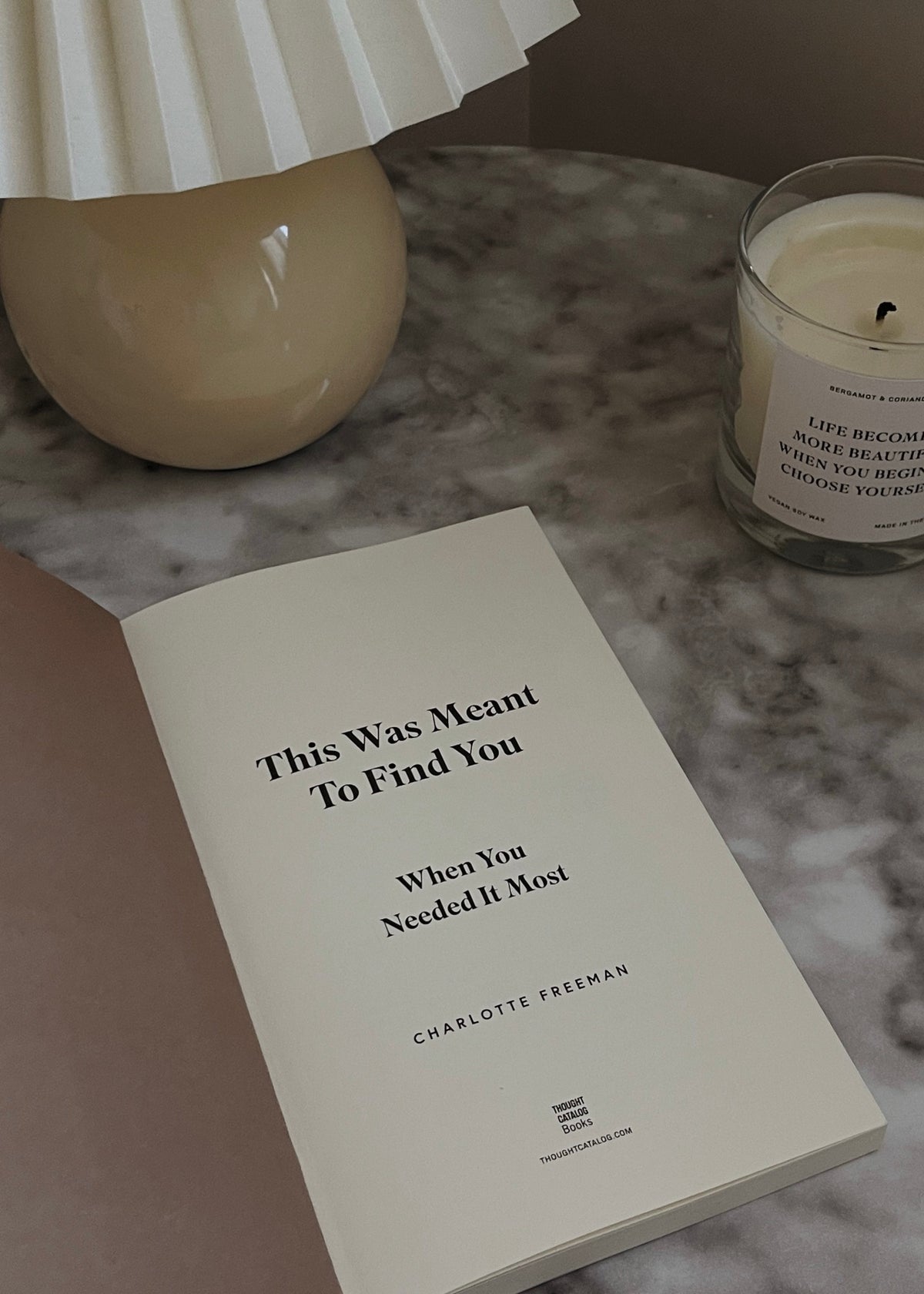 This Was Meant To Find You by Charlotte Freeman styled beside a candle