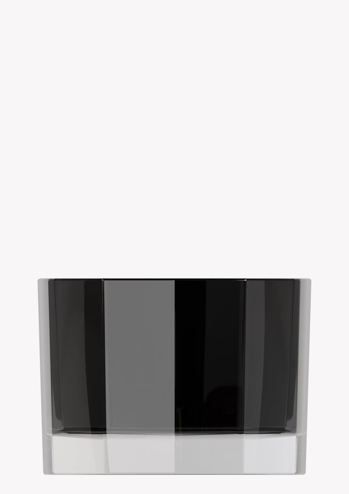 Single half-moon Blend candle in faceted black glass on a pale grey background