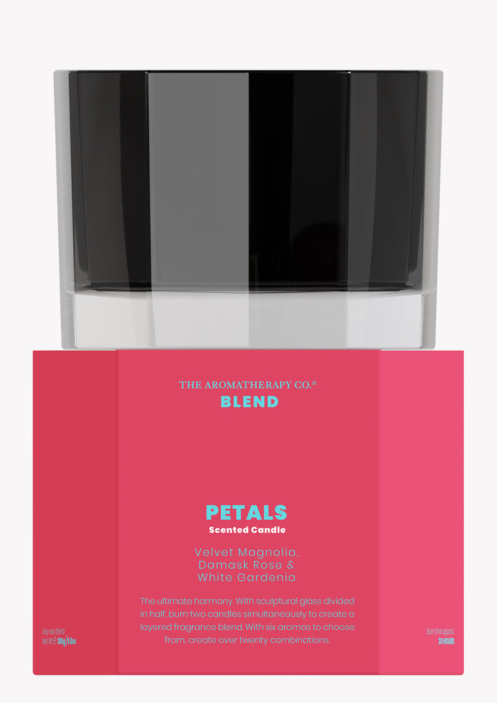 Blend Petals scented candle in black glass stacked on its raspberry pink box