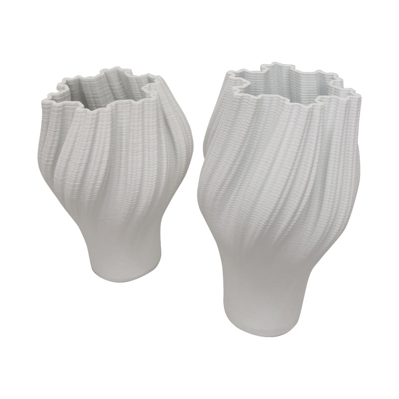 Two white 3D printed porcelain vases in the two sizes, side by side on a plain background