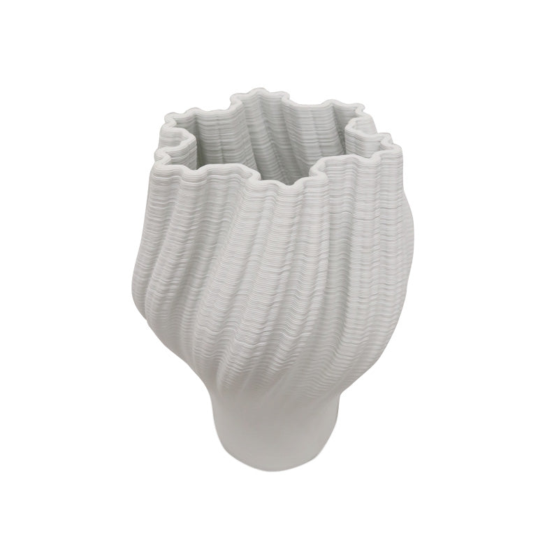 White 3D printed porcelain vase at an angle, showing the ridged texture