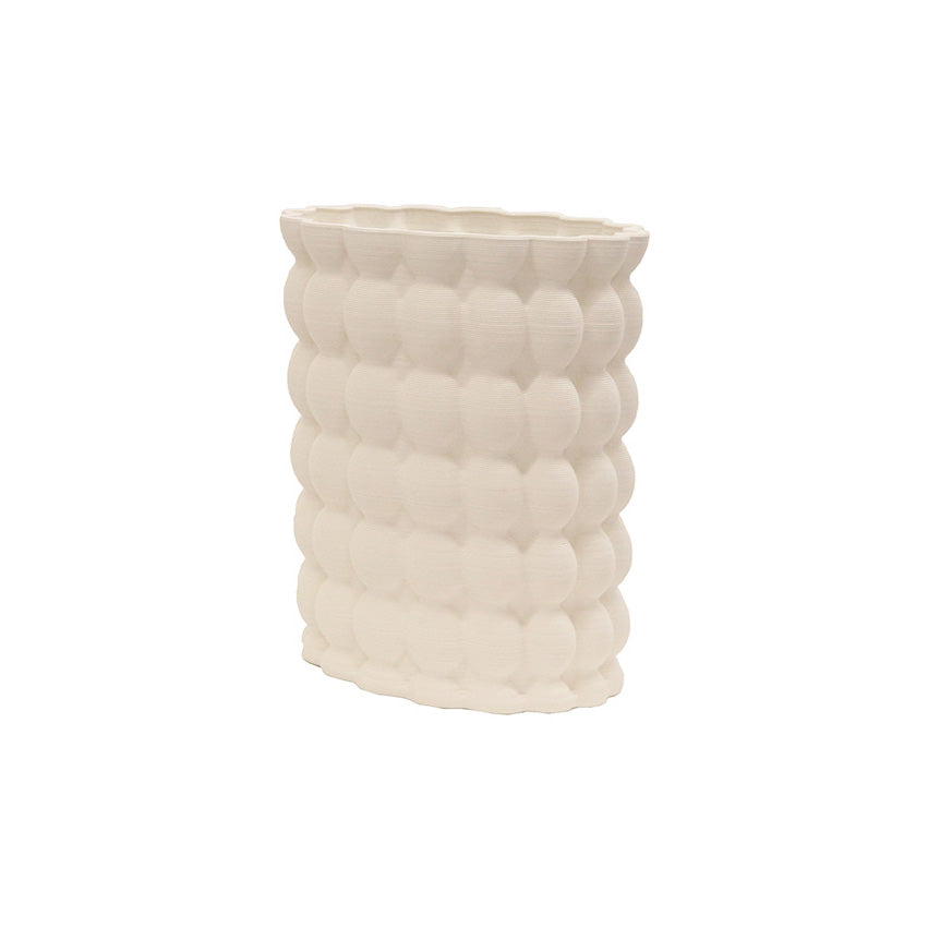 Ribbed porcelain vase in white, rows of rounded bumps across an oval body