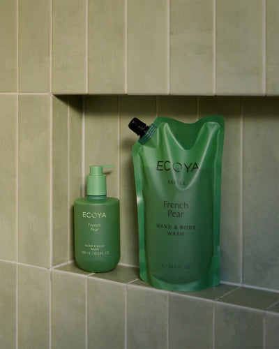 Ecoya French Pear refill pouch and bottle in a green tiled shower niche