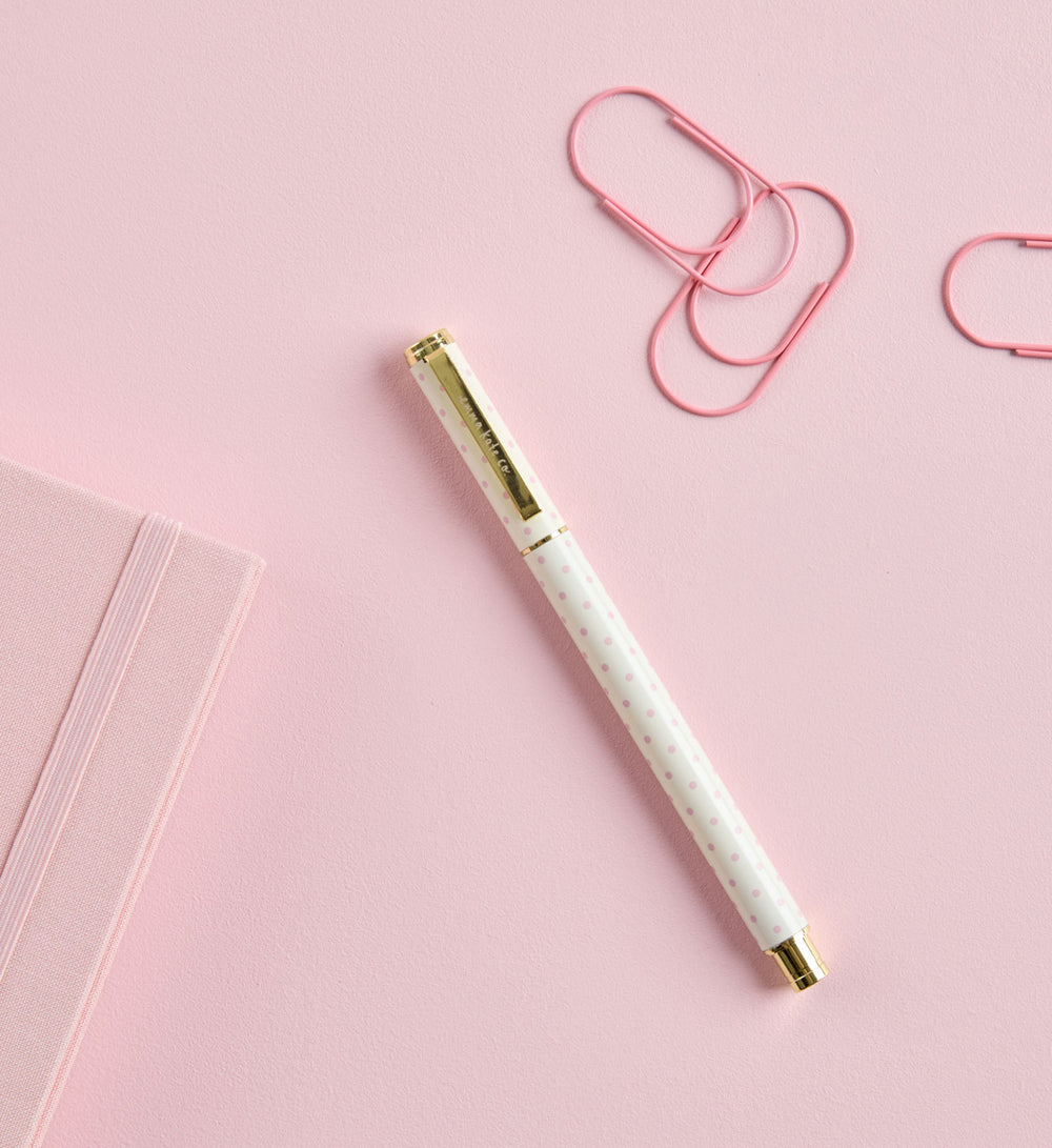 Metal Rollerball Pen in Tutu styled on desk with notebook by Emma Kate Co