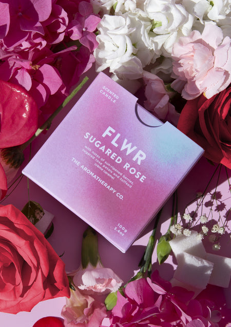 The pastel FLWR Sugared Rose carton among pink and red roses, hydrangea and gypsophila