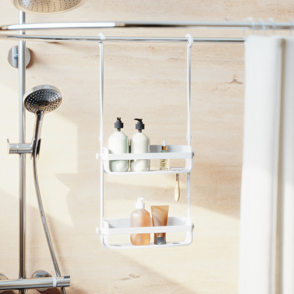 White Flex shower caddy hung from a shower rail, holding bottles