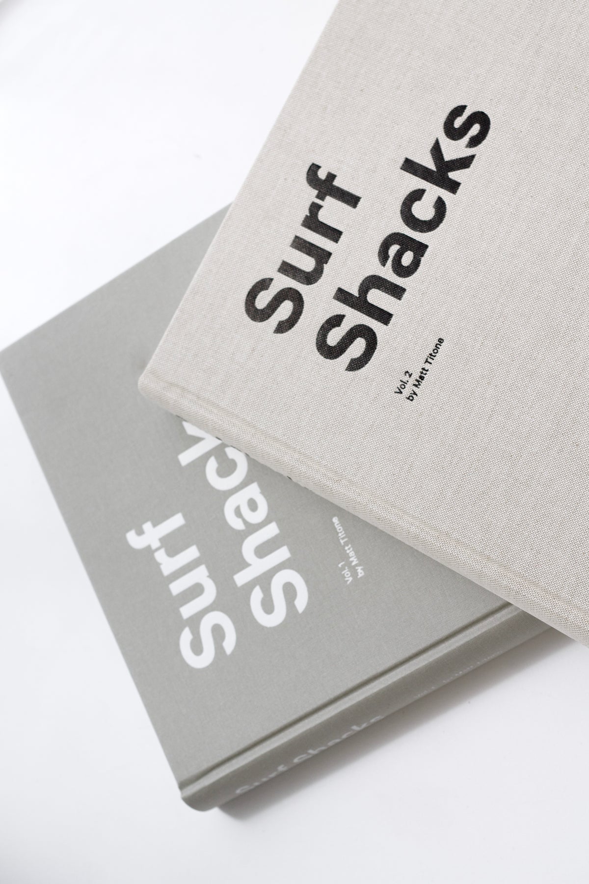 Surf Shacks Volume 2 and the first Surf Shacks book in linen covers, close-up