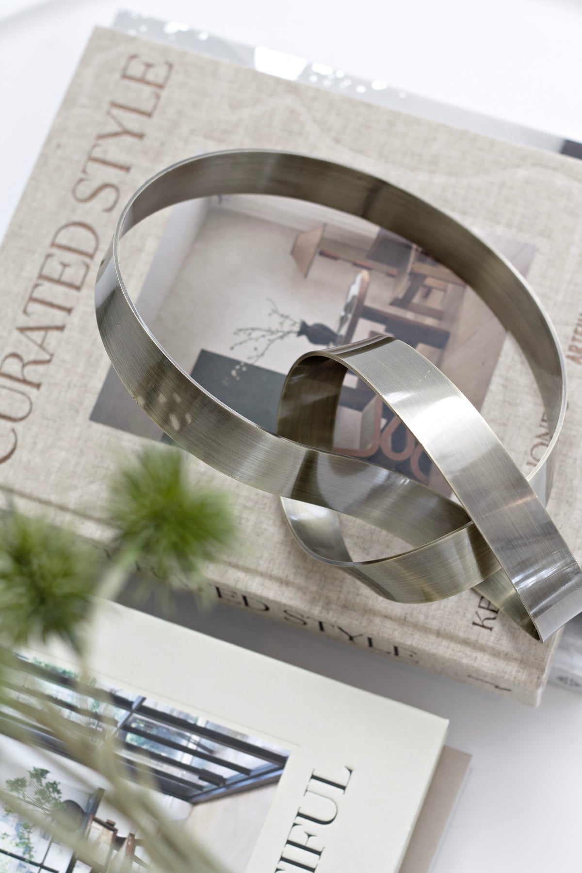Close up of Infinity Loop Life Sculpture brushed metal finish
