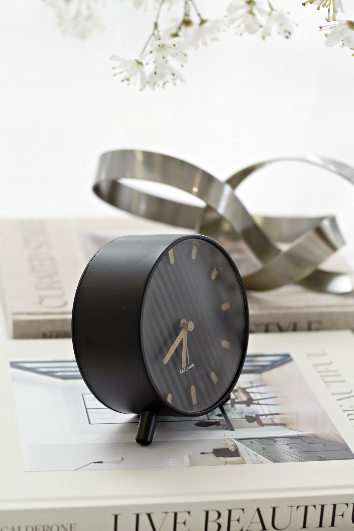 Karlsson Grace Alarm Clock styled on a bedside surface