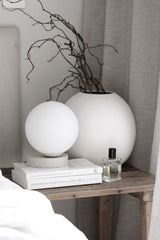 An organic Yuri Table lamp by Ned Collections on a bedside table.