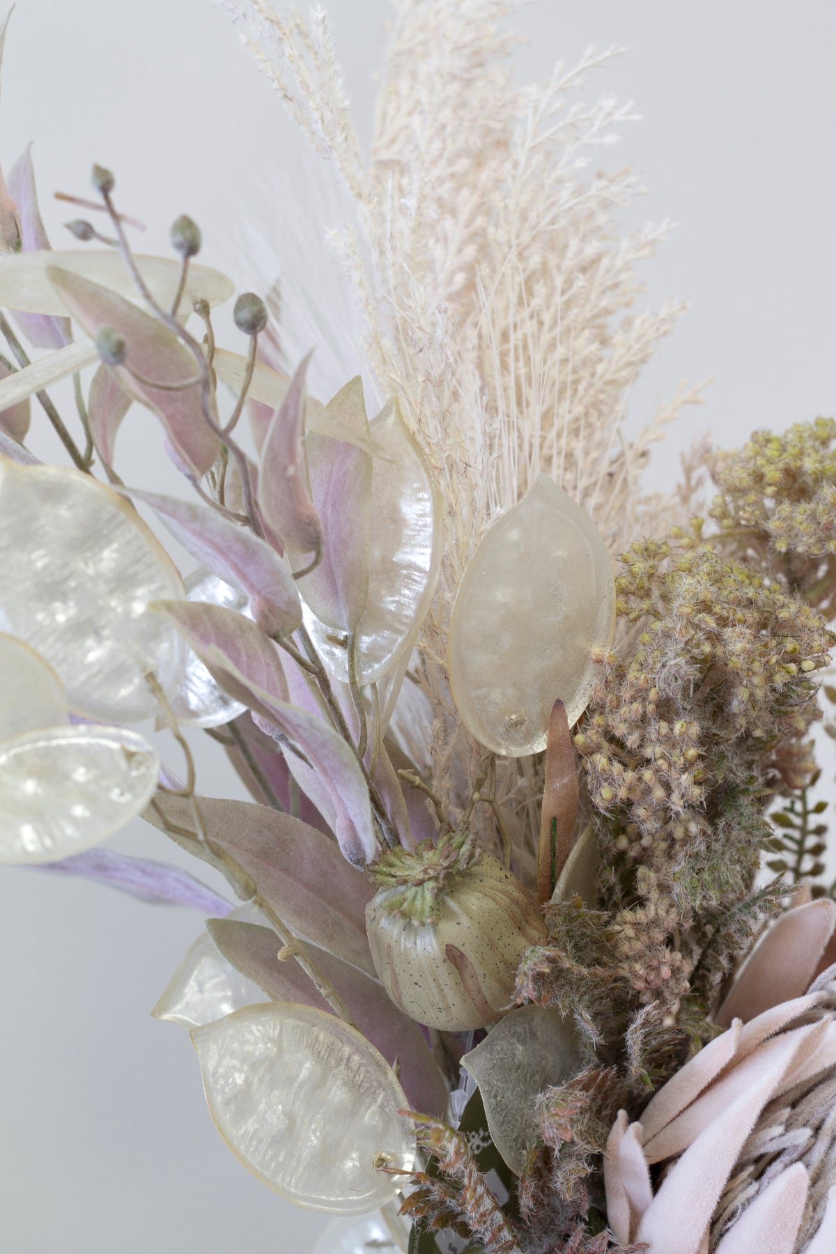 Tall mix of pink foliage, dried grass and wild flower spray