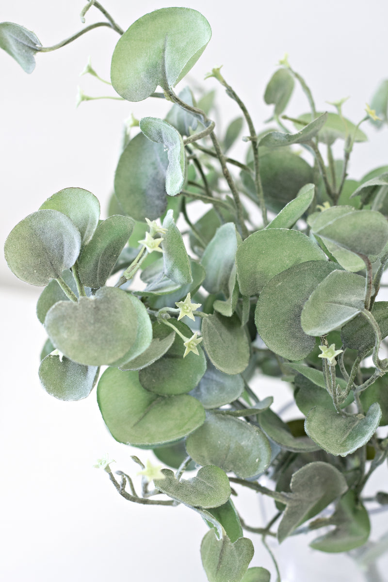 Silver Falls Bush 30cm arranged in a vase, adding a touch of greenery to a white table. (Brand: Artificial Flora)