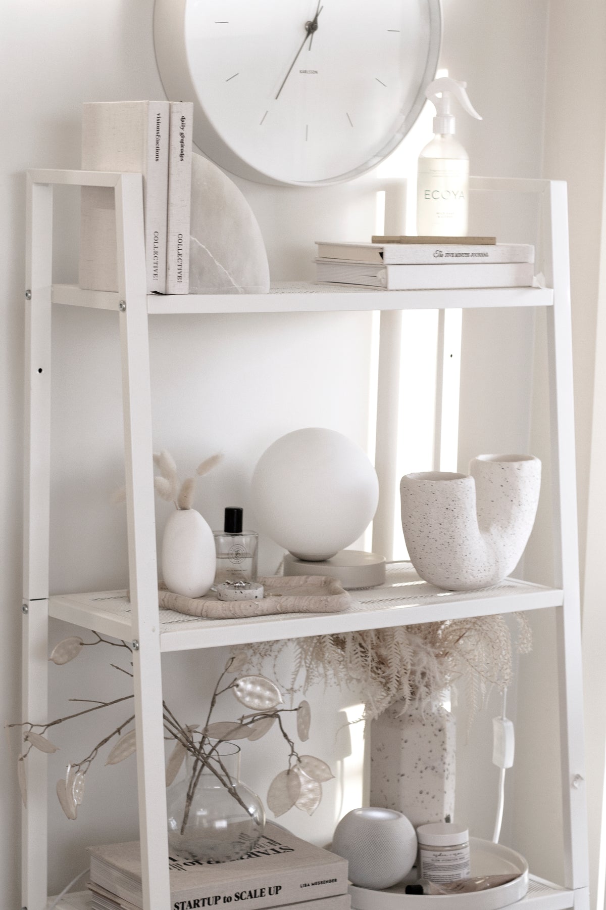 An elegant white Yuri Table lamp from Ned Collections on it.