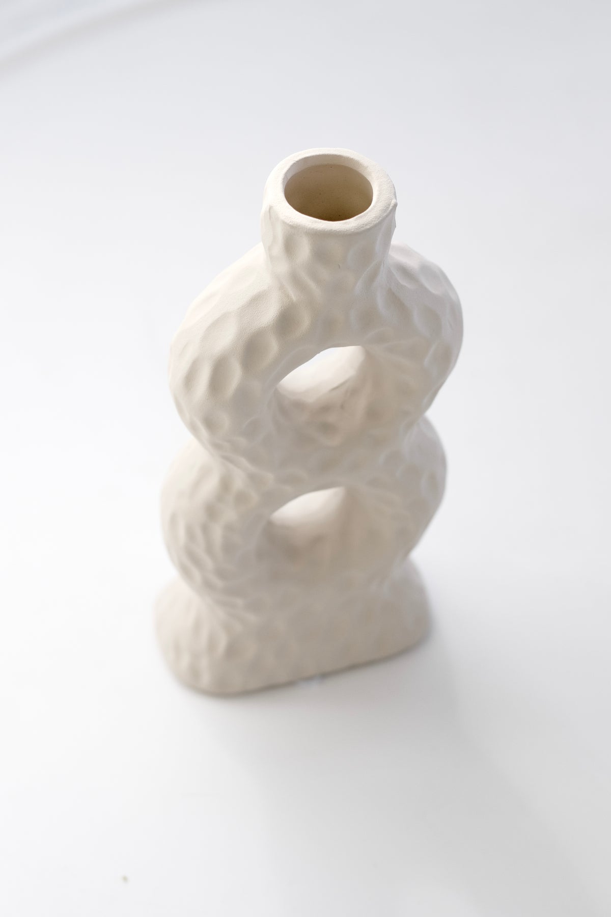 Sicily Loop Ceramic Vase with two loop openings and textured finish, soft grey backdrop