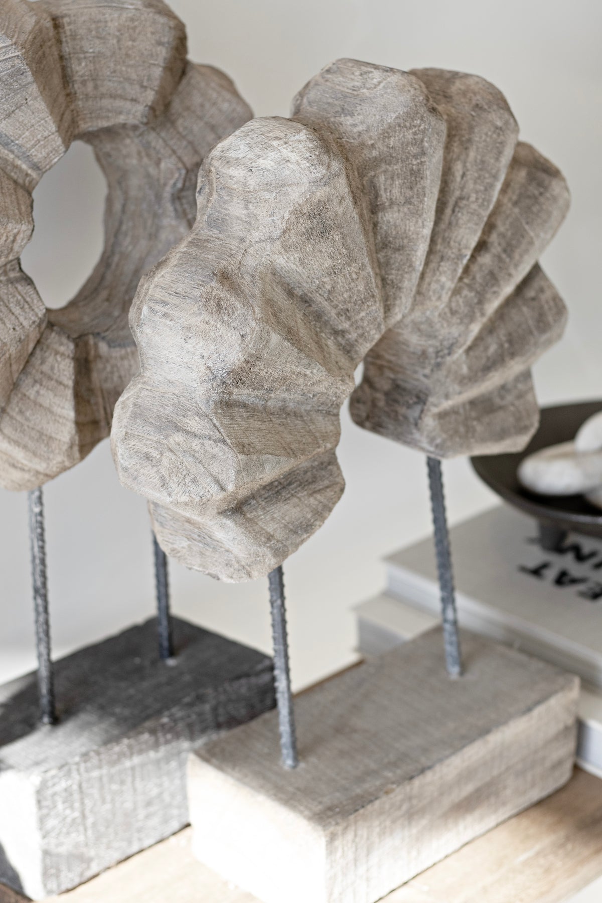 Two timber arch sculptures side by side on their wooden bases, closely cropped