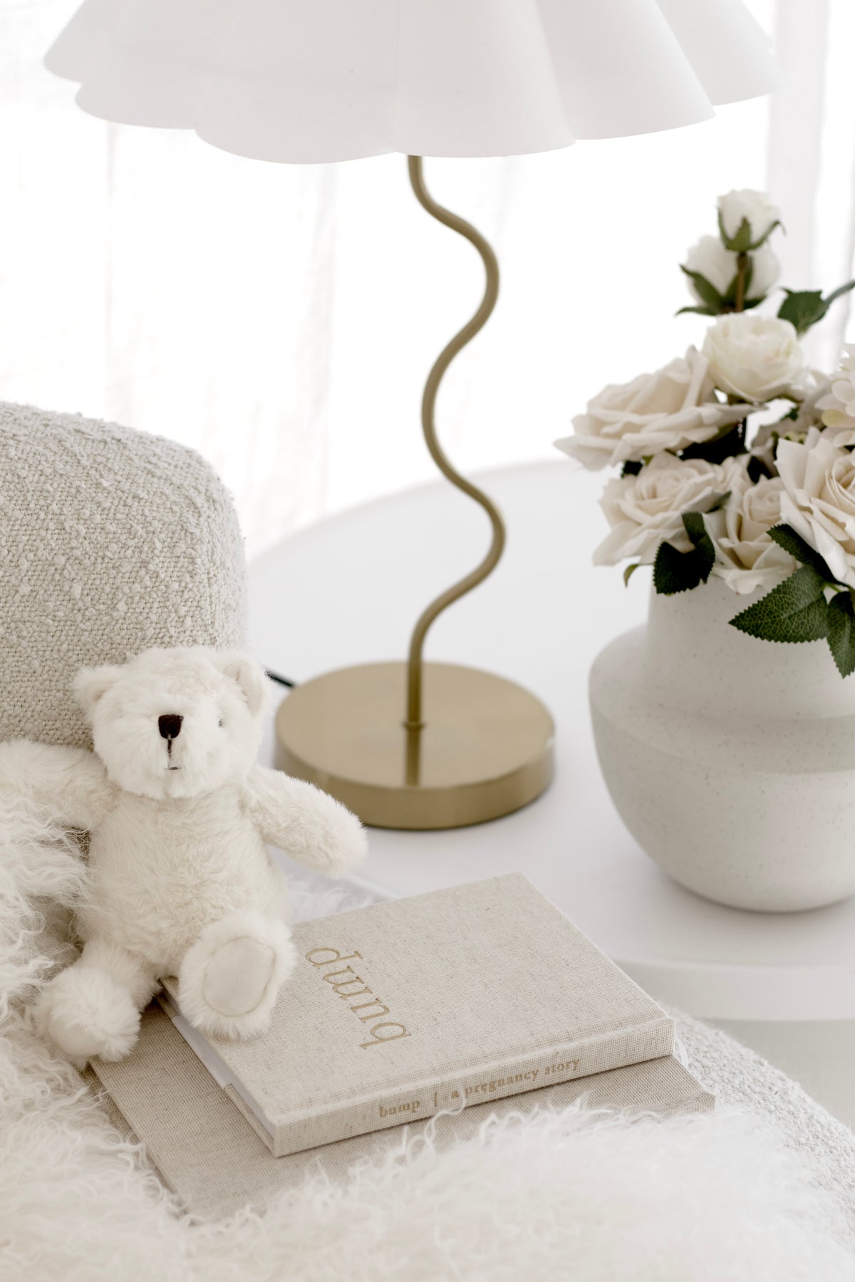 Second view of the Bump journal on a bedside table with a plush bear and a wavy lamp