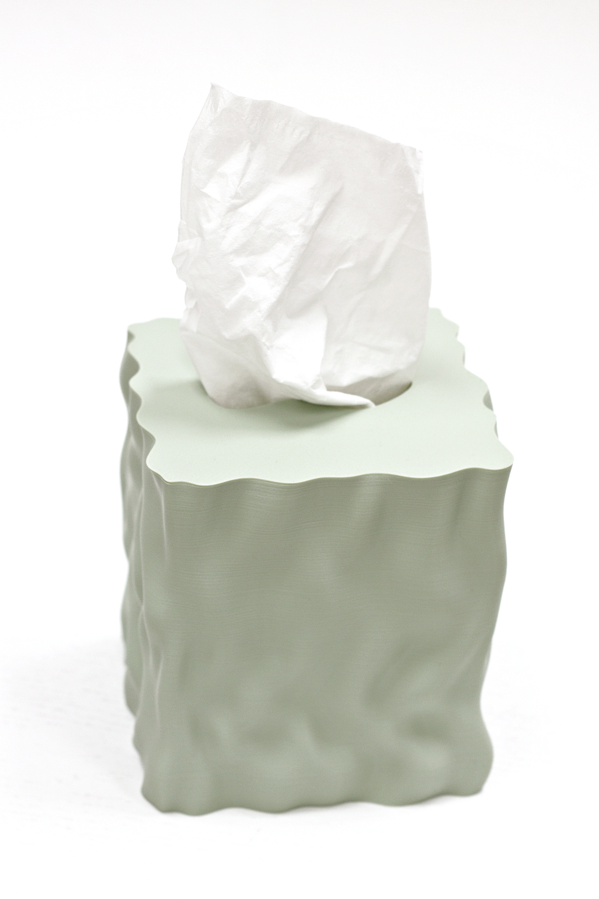 Sage Flow tissue box cover with a tissue on a white background