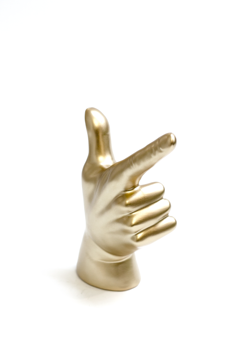 A Lucky Hand pointing at something on a white background near a bookshelf. (Brand: Flux Home)