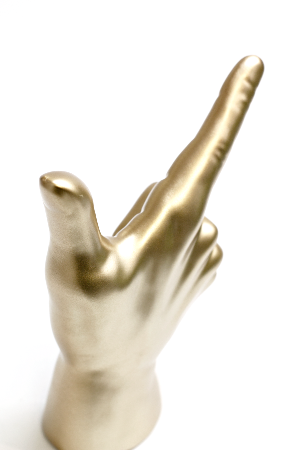 Gold Lucky Hand photographed close from below, the raised finger filling the frame