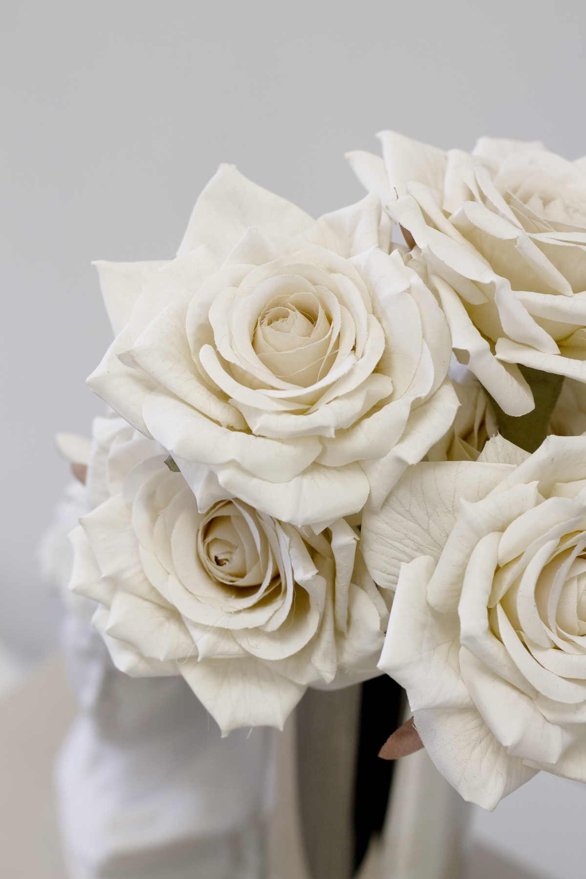 Close view of champagne roses in a silver vase