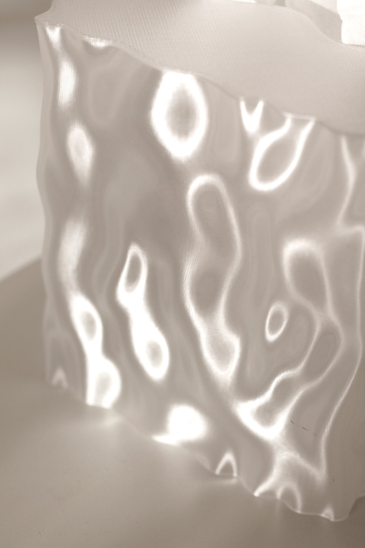 Clear Flow cover casting rippled light and shadow in a dim room
