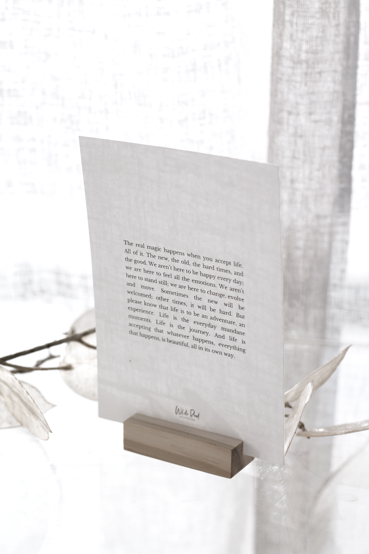 Affirmation card on its wooden stand by a window