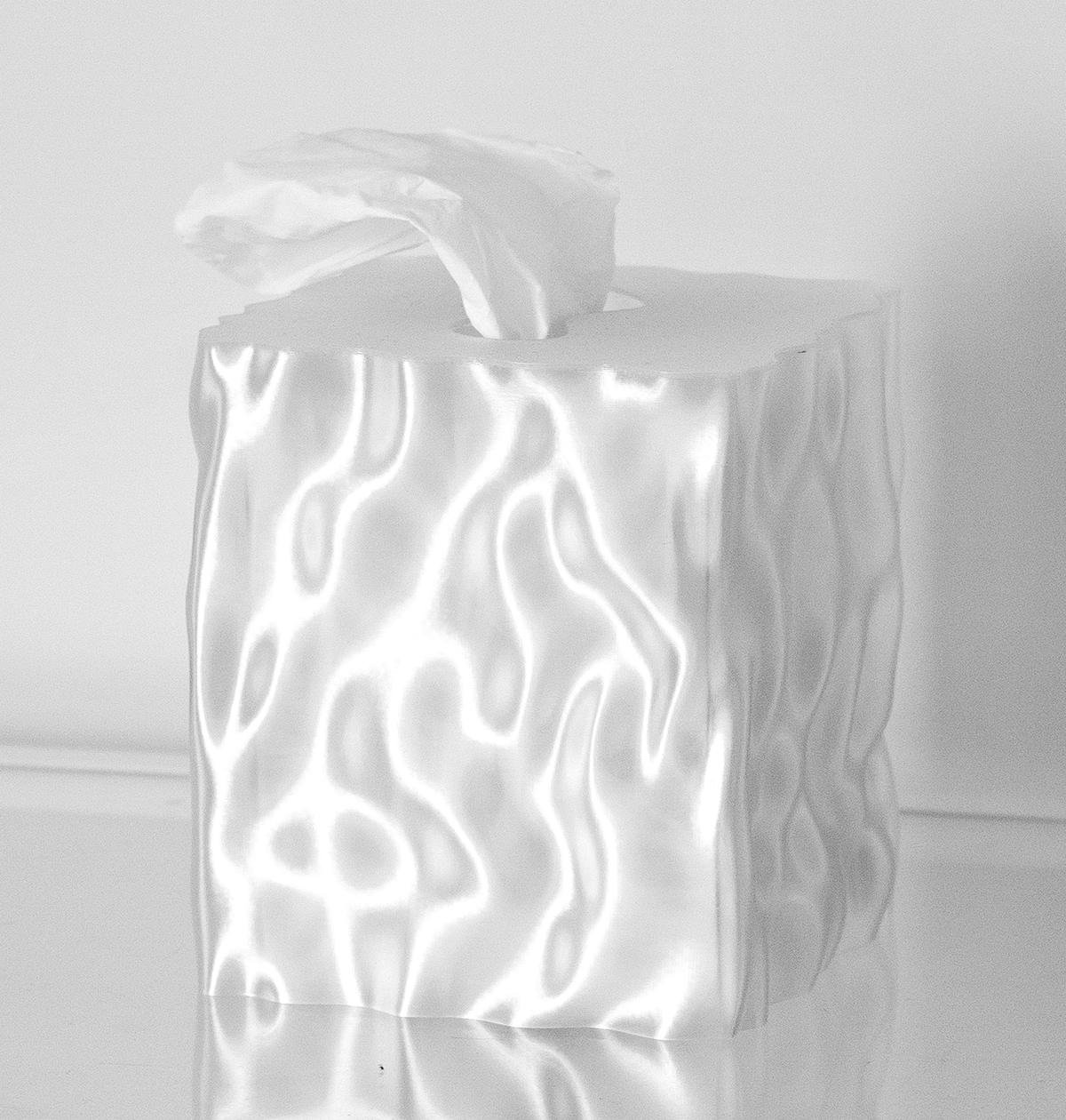 Clear translucent Flow tissue box cover glowing with rippled light