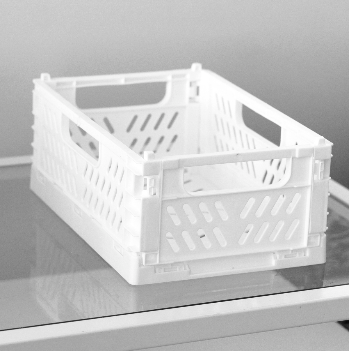 Assembled white crate on a grey topped surface, handles cut into the end panels