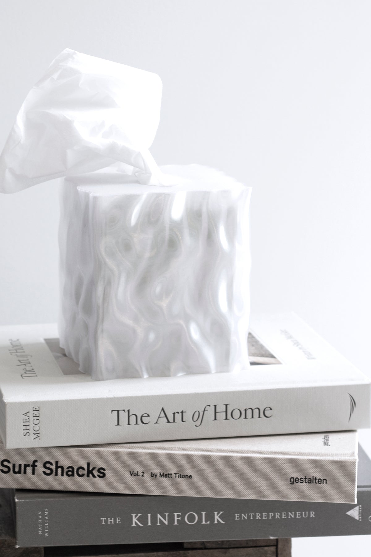 White Flow tissue box cover on a stack of coffee table books