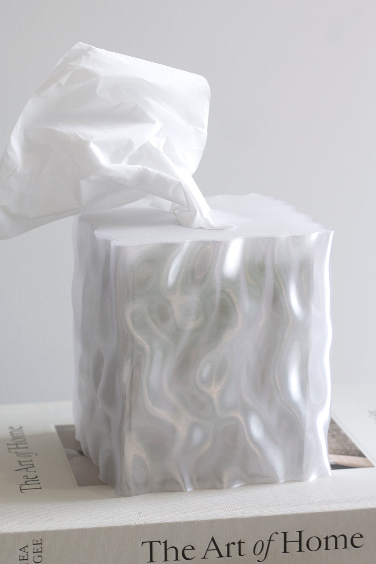 White Flow tissue box cover on a coffee table book in soft light