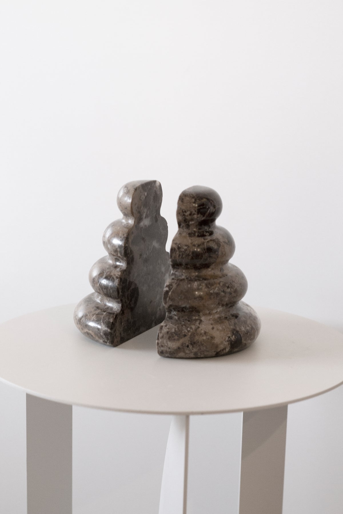 Pair of Casa bookends on a round white side table