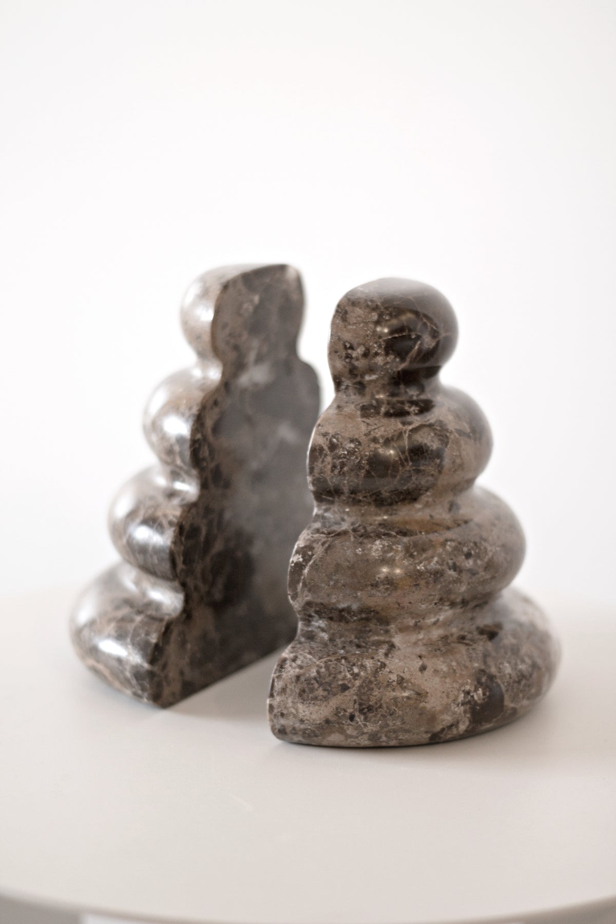 Pair of Casa bookends on a white table, angled view
