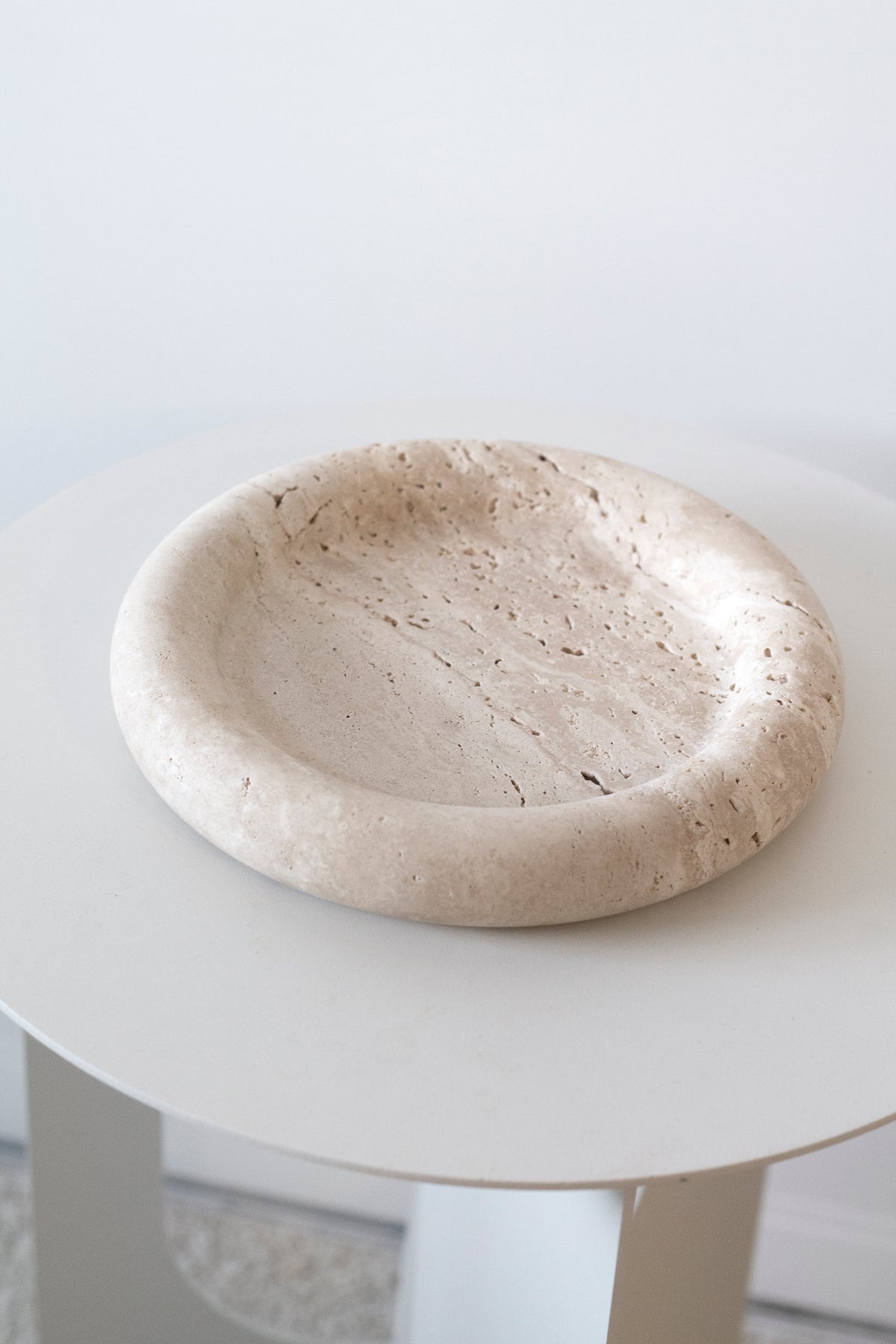 Bay Round Tray from above, showing the pitted light travertine surface