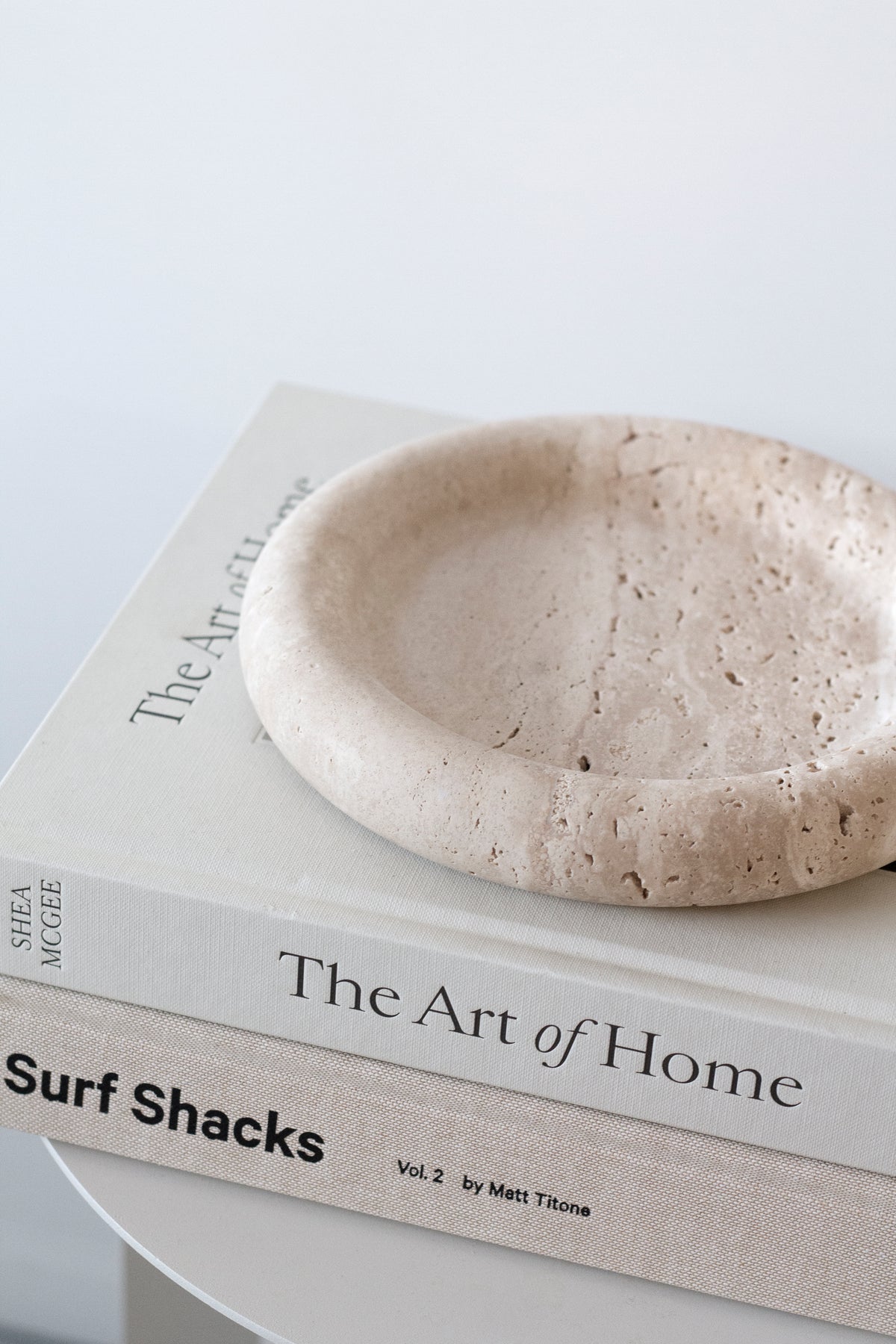 Bay Round Tray balanced on stacked coffee table books, seen from a low angle