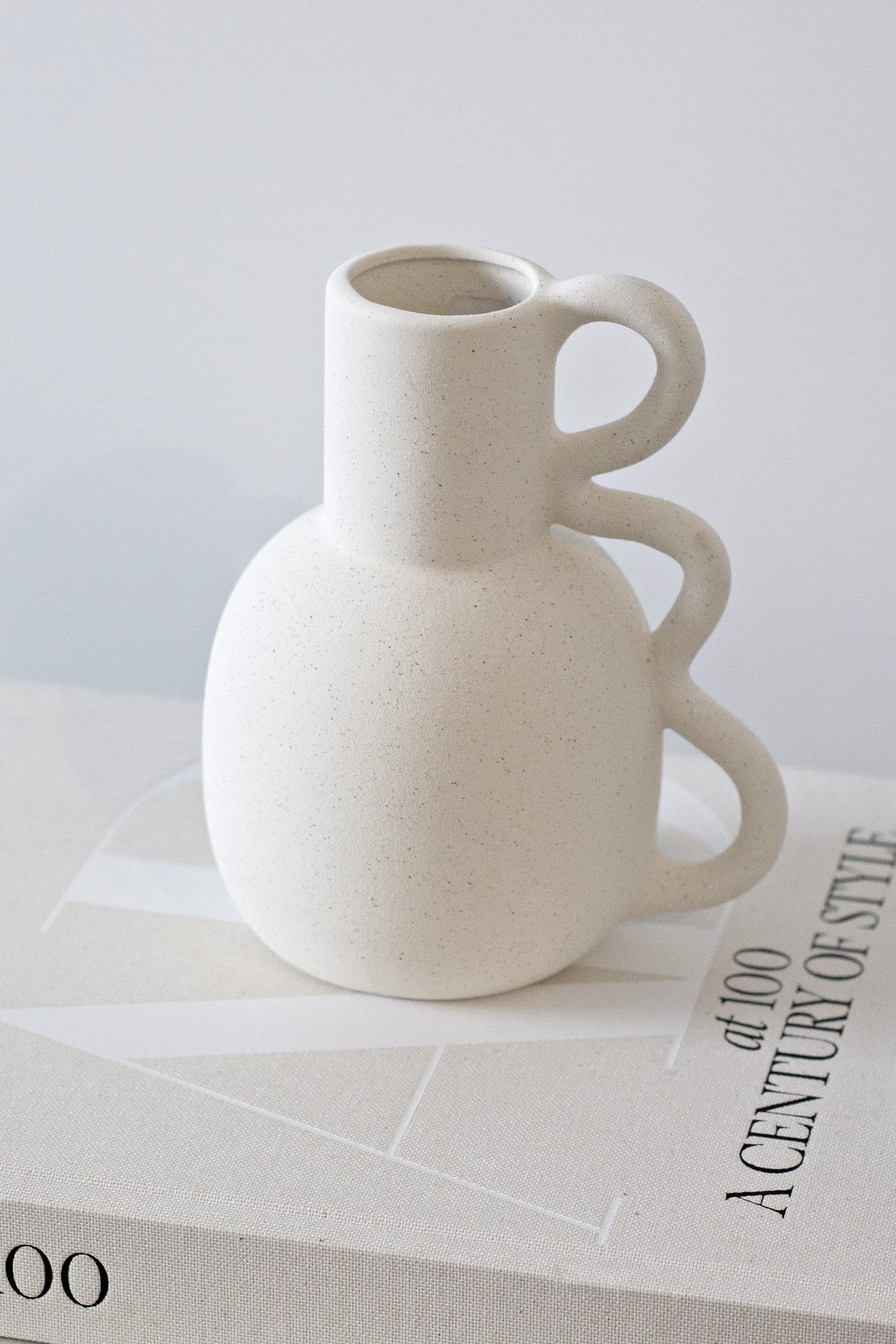 Chloe vase resting on a hardback book on a white surface