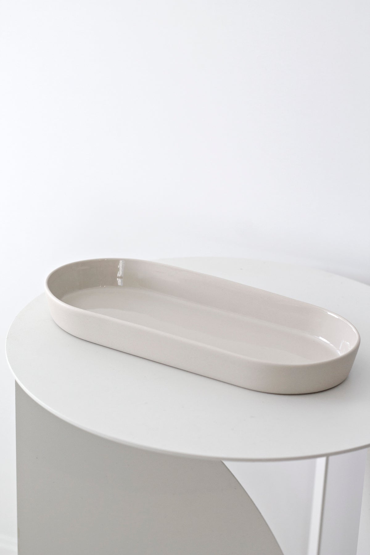 Noosa dish styled on a bathroom vanity with soap and skincare