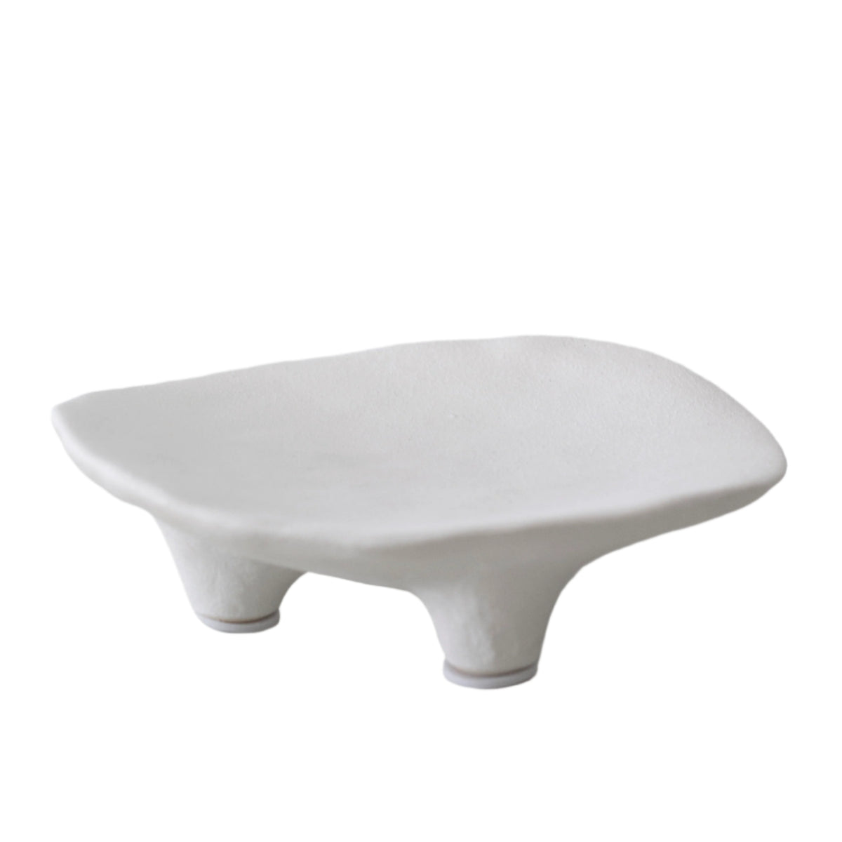 White ceramic dish with a softly irregular rim, raised on three short sculptural feet