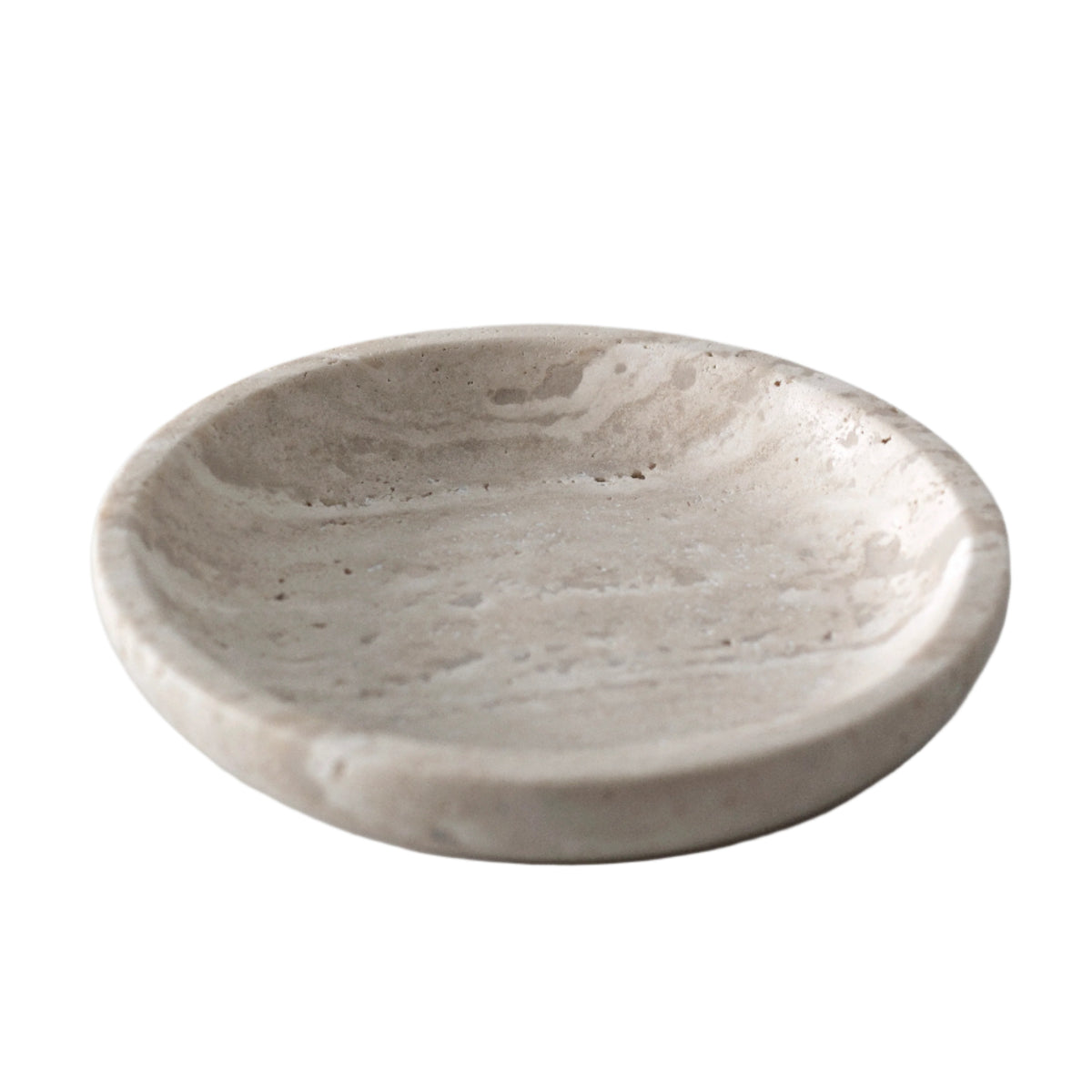 Round travertine tray in natural stone, a shallow dish with warm beige banding
